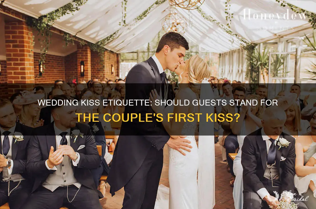 do people stand before the couple kisses at a wedding