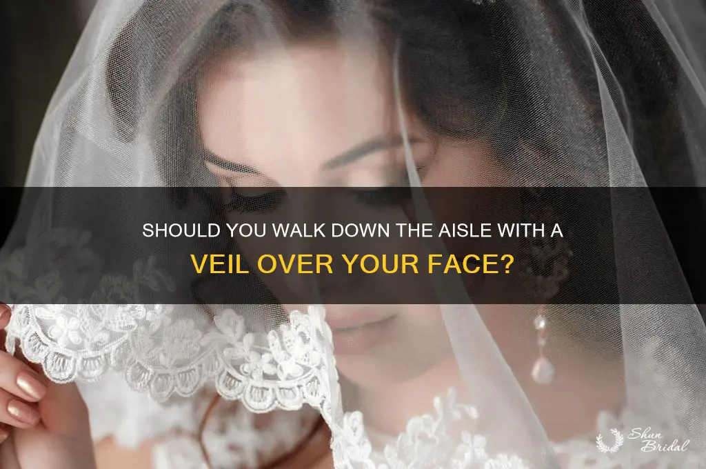 do you walk down the aisle with veil over face
