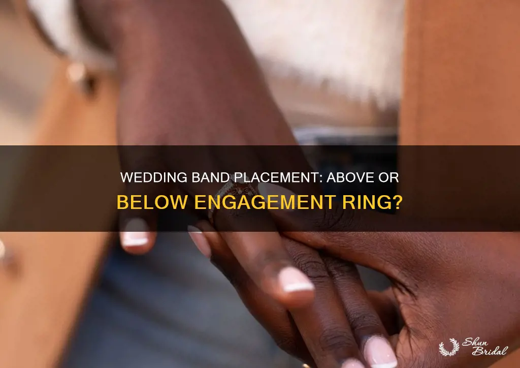 does the wedding band go above or below engagement ring