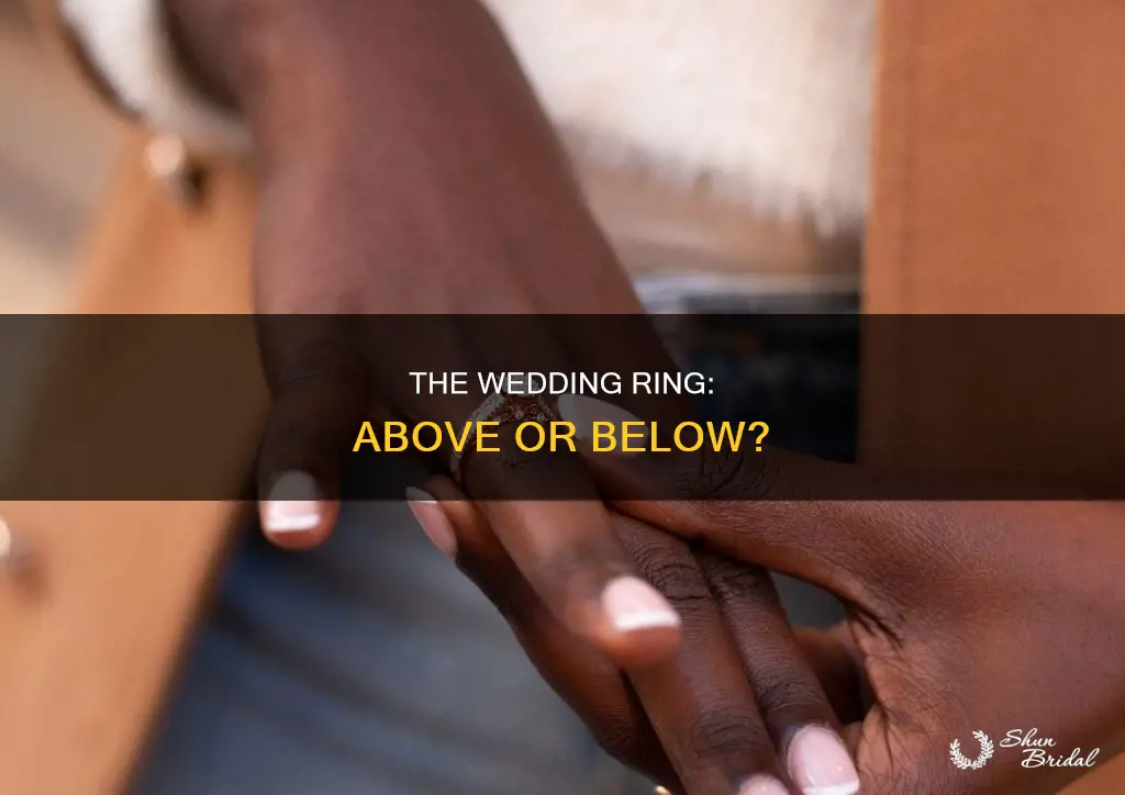 does the wedding ring go above or below
