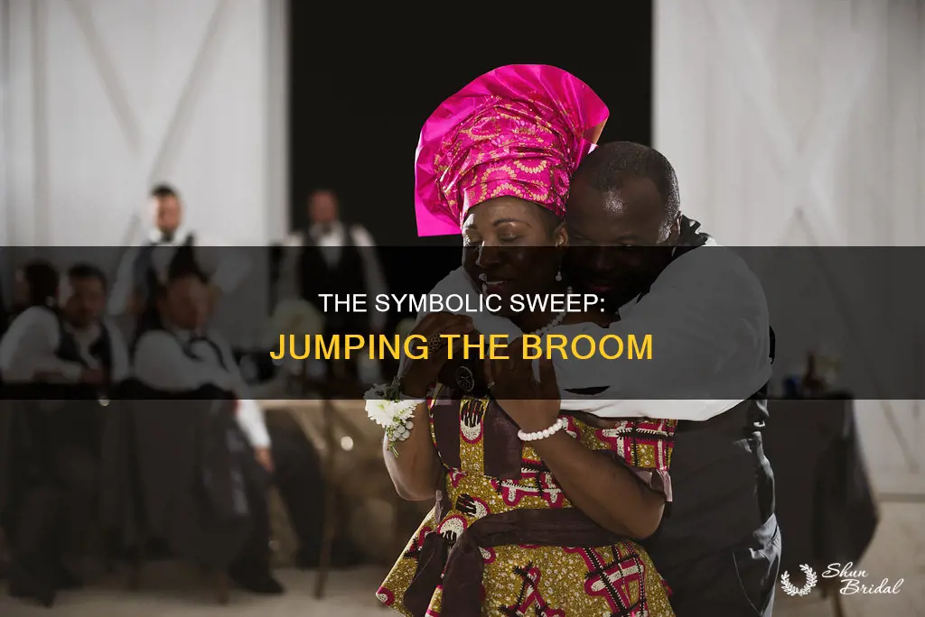 what is the old.wedding tradition of.jumpingover a broom mean