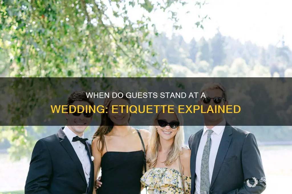when do guests stand at a wedding