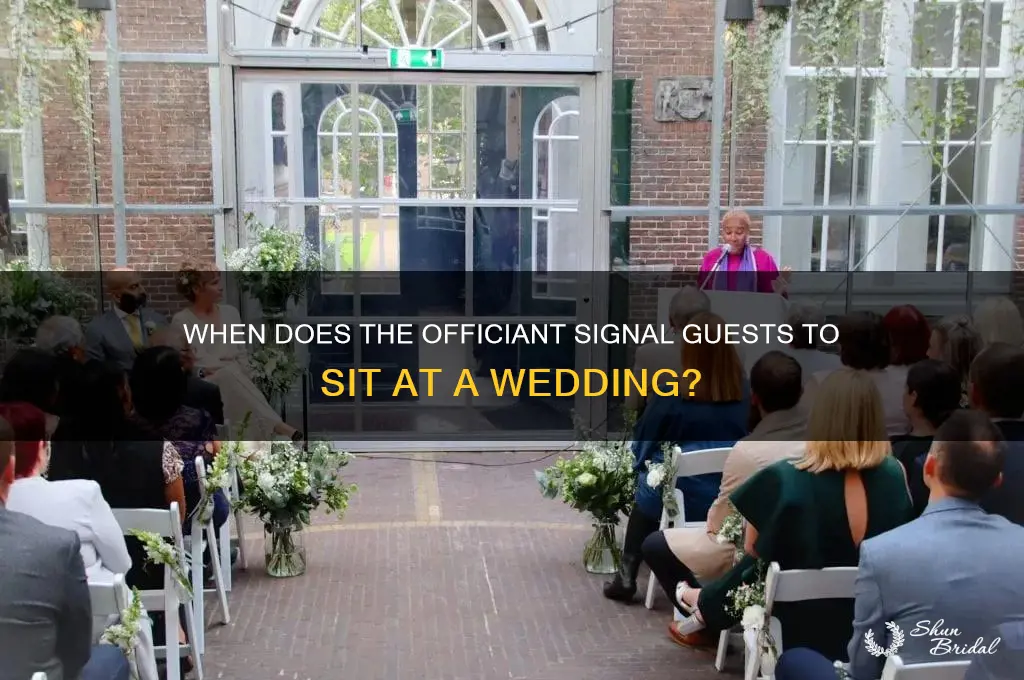 when does the officiant tell everyone sit down at wedding